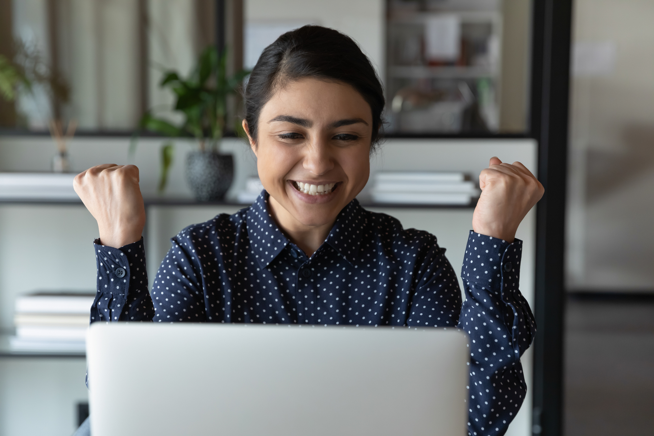 Happy, young, female, Indian professional working on a computer